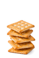 Stacked pile of crispy saltine crackers, isolated on white background