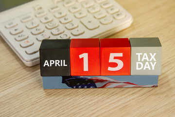 Tax day concept. US tax due date, calendar block, tax deductions. USA flag