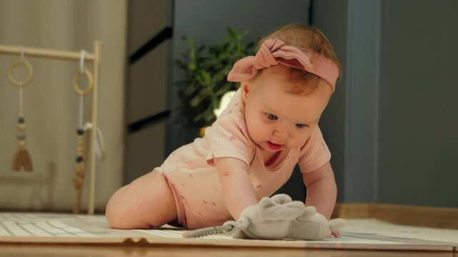 An Adorable Baby Joyfully Crawling Around on a Colorful Playmat. First Steps