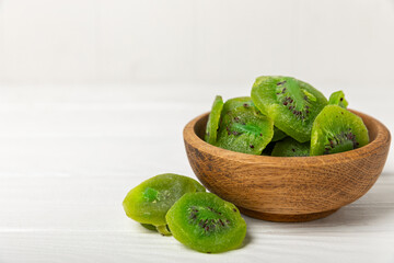 Kiwi dried fruit on wooden background. kiwi candied fruit. Healthy food. Ingredient for baking cupcakes. Healthy snack, vegetarian sweets. Space for text. Copy space