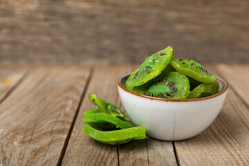 Kiwi dried fruit on wooden background. kiwi candied fruit. Healthy food. Ingredient for baking...