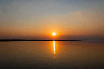 Beautiful calm lake with sunset in Thailand.