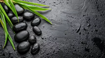 Calming Stones and Bamboo Leaves Arrangement on Smooth Black Surface for Relaxation and Aesthetic Decor
