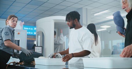Security Check in Airport: Queue of Multiethnic People, Passengers Putting Bags, Personal Items in...