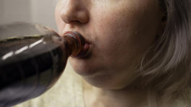 fat woman drink soda water from bottle, female overweight person drinks cola