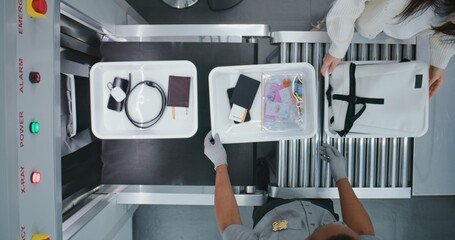 Diverse People, Travelers Putting Personal Items in Plastic Trays for X-ray Scanning on Conveyor...