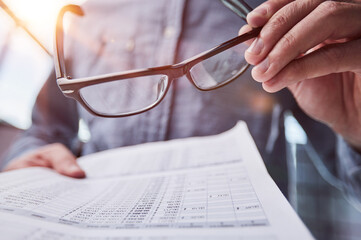 businessman reviewing document reports at office workplace.