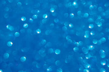 A blue bokeh-style background with defocused light creates an elegant space for text or design elements.