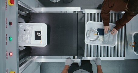 Top View on Diverse People, Passengers Putting Personal Items in Plastic Trays for Screening...