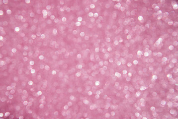 A soft pink bokeh-style background with unfocused light creates an elegant space for text or design elements.