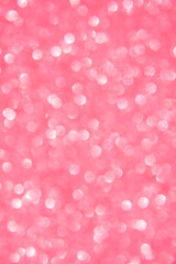 A soft pink bokeh-style background with unfocused light creates an elegant space for text or design elements.