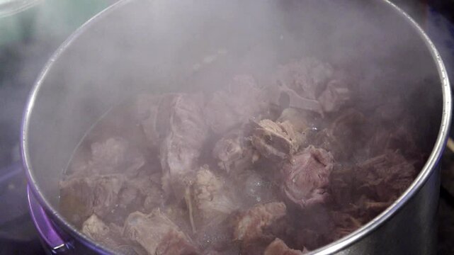 Pork backbones cooking in a sot
