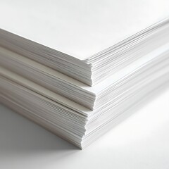 Paper stack on white surface, soft light