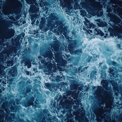 Naklejka premium Azure Depths: A mesmerizing view of churning ocean water, its dynamic patterns of waves and foam captured in shades of blue and turquoise.