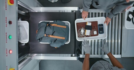 Top View on Diverse People, Passengers Putting Personal Items in Plastic Trays for Screening...