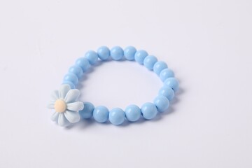 One blue hair tie with flower on white background