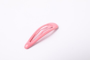 One pink hair clip on white background