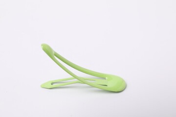 One green hair clip on white background