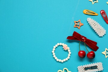 Different hair accessories on light blue background, flat lay. Space for text