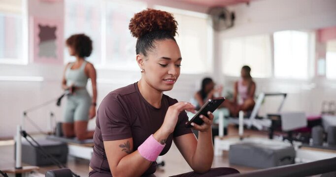 Happy woman, gym and browsing with phone for fitness, sports app or news at health club. Active, female person or athlete with smile on mobile smartphone for workout break, exercise or training tips