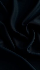 Fototapeta premium Luxurious black textile, soft, flowing folds, dramatic shadows, dramatic folds, velvet, smooth