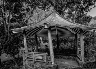 Crooked Gazebo with a Nature Background in Black and White.