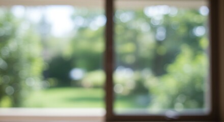 Blurred view through a window showcasing a vibrant garden in soft focus