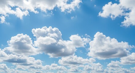 Fototapeta premium Bright blue sky filled with fluffy white clouds, creating a serene atmosphere