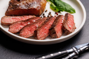 A perfectly cooked sliced striploin steak with a juicy, tender texture