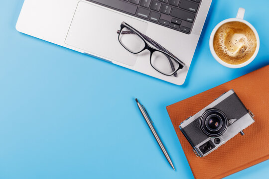 A clean and minimal desk setup featuring a laptop and a coffee cup