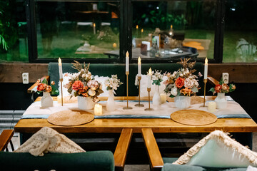 Soft Glow of Candle Light Enhancing an Indoor Wedding Setup with Green Chairs