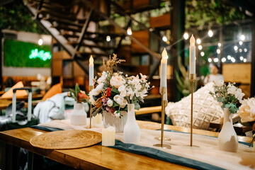 Cozy Indoor Wedding Setup with Green Chairs and Candle Light Ambiance