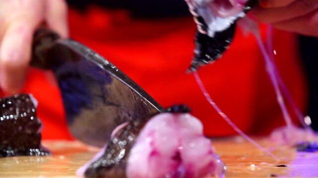 Cutting fresh sea raven with a sharp knife