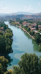 River flows through city with mountains behind