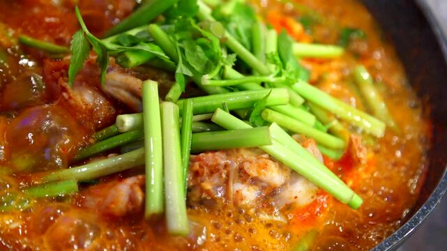 Spicy shaggy sea raven stew boiling in a pot