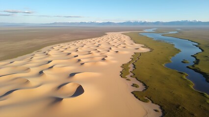 Dramatic Mongolian desert landscape featuring sand dunes, a winding river, mountains, and grassland.