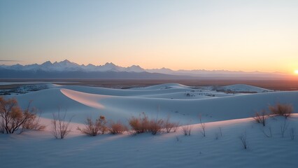 Fototapeta premium Snowy Sand Dunes and Mountain Range at Sunset: A Serene Winter Landscape