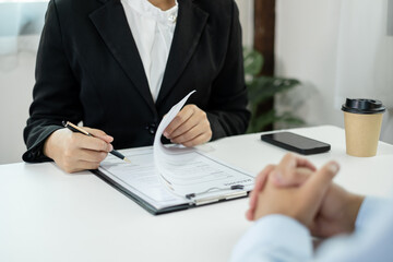 Business people hold a resume and talk to job applicants for job interviews about careers and Their...