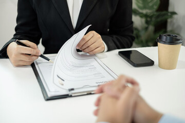 Business people hold a resume and talk to job applicants for job interviews about careers and Their...