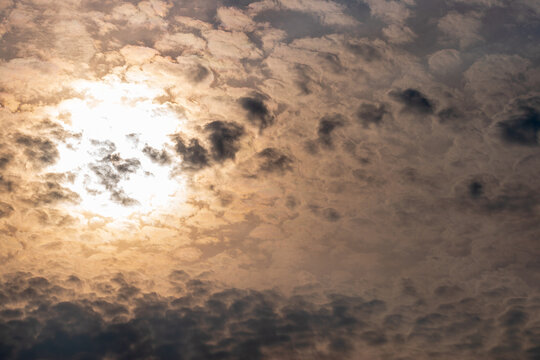 Pewter plasma sky with sun behind clouds