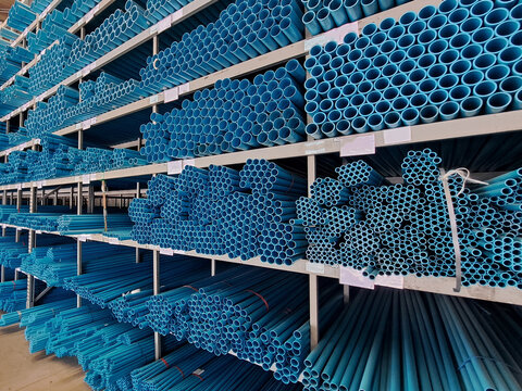 Pvc pipes background.Stacked plastic pipes in a warehouse. Pvc pipes for construction.