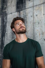 A Pensive Man Gazing Upward: A Contemplative Portrait Against a Textured Urban Wall