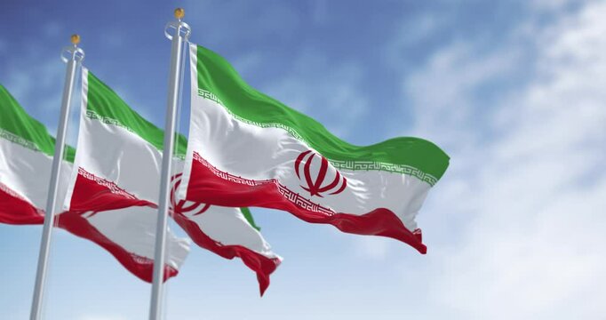 Three national flags of Iran waving in the wind on a clear day