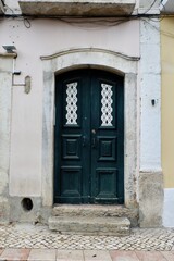 Vintage shabby door with old-fashioned ornate downtown Lisbon, Portugal