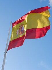 Flag of Spain on the pole moving by wind photo