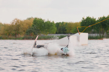 The wakeboarder fell and released the cable at the moment of falling. He failed to perform the trick