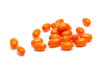 Scattered sea buckthorn berries with a vibrant orange color against a white background. The small, oval berries have a smooth, glossy surface and appear fresh