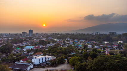 Chiang Mai urban landscape at sunset with Doi Suthep mountain in the background with pollution