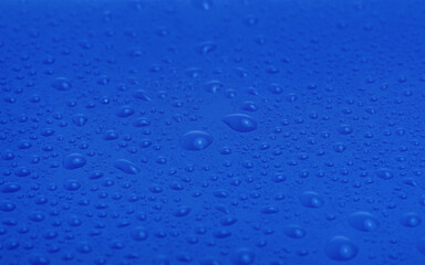 Blue plastic with water drops macro photo.
