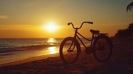 Fototapeta premium A bicycle silhouette rests on a beach during a beautiful sunset